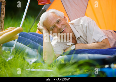 Senior man relaxing in tent, portrait Stock Photo