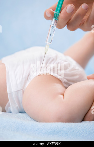 Female doctor injecting baby, close-up Stock Photo