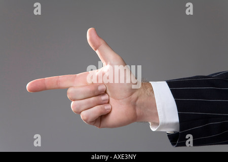 Man making hand gesture, pointing, close-up Stock Photo