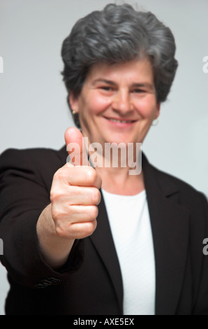 Portrait of a mature businesswoman showing thumb up Stock Photo