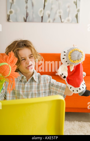 Boy (6-7) playing with glove puppet, portrait Stock Photo