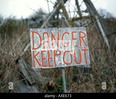 Old danger sign in countryside Stock Photo