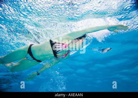 Underwater shot of Asian woman swimming Stock Photo
