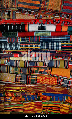 Stack of brightly coloured West African strip textiles Ewe fabrics from Ghana Stock Photo