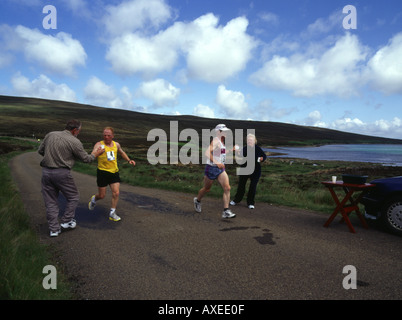 dh Hoy half marathon HOY ORKNEY Two runners taking on water at drink stop at Rysa Bay race run Stock Photo