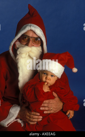Santa Claus and his little apprentice boy. Père Noël. Paire Noël. Stock Photo