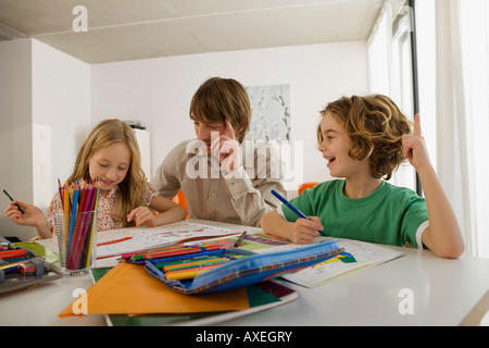 Father and children doing homework Stock Photo