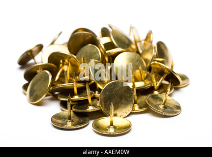 Pile of gold drawing pins or thumb tacks on white background cut out silo Stock Photo