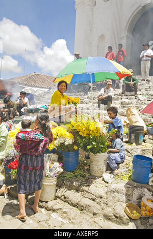 GUATEMALA CHICHICASTENANGO Local vendors sell everything from flowers and incense to vegetables on the steps of Santo Tomas Stock Photo