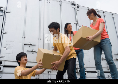 Young people carrying boxes Stock Photo