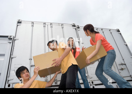 Young people carrying boxes Stock Photo
