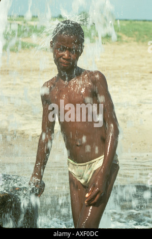 Africa Namibia Ovamboland Boys play in water Stock Photo