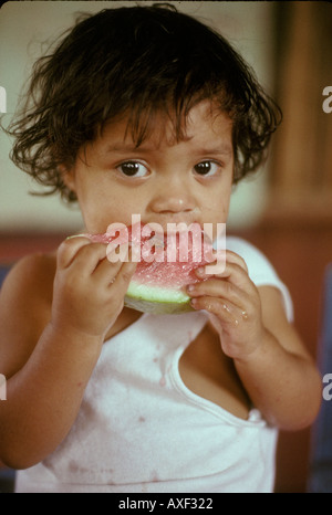 Americas Nicaragua Orphan eats melon Stock Photo