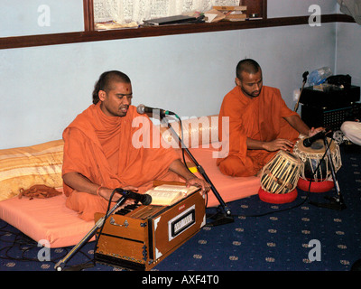 Shree Swaminarayan Temple Streatham London England Musicians Playing in Orange Robes Harmonium and Tabla Drums at Diwali Stock Photo