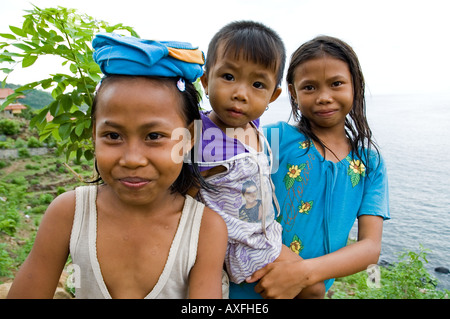 Young girls greet visitors in the small coastal town of Amed Bali Stock ...