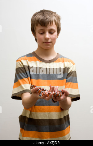 Boy holding pet snake Stock Photo