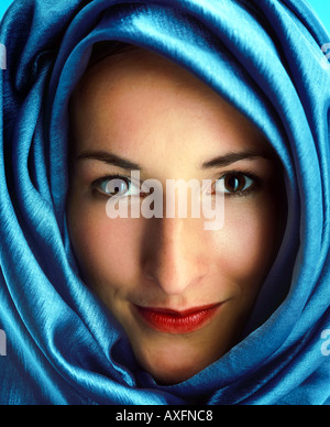 Woman with a blue shawl wrapped around her head. Stock Photo