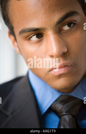 Close up of a young dark skinned business man looking very serious Stock Photo