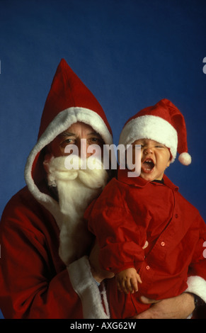Santa Claus and his little apprentice. Père Noël and his little assistant. Paire Noël. Stock Photo