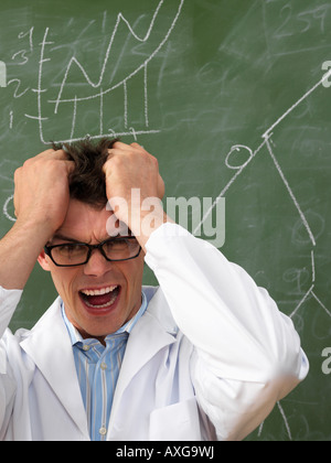 Confused Scientist in Front of Blackboard Stock Photo