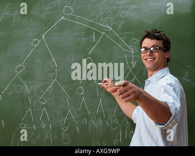 Teacher at Blackboard Stock Photo