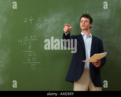 Teacher Standing in Front of Blackboard Stock Photo