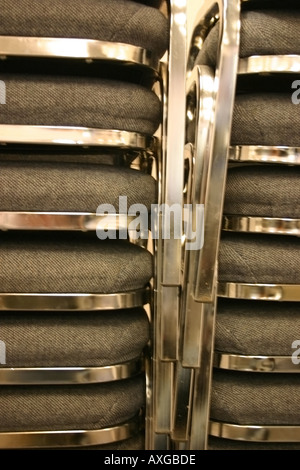 Chair on top of chair create a shiny ribcage of sorts. Stock Photo