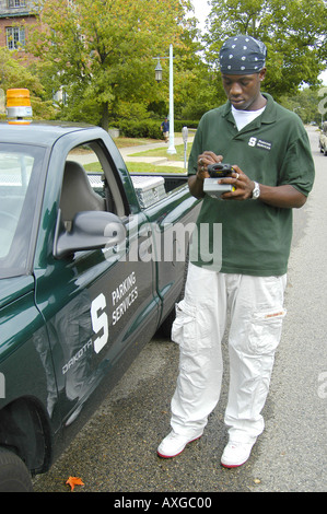 Black Michigan State University student works part time with campus parking enforcement services Stock Photo