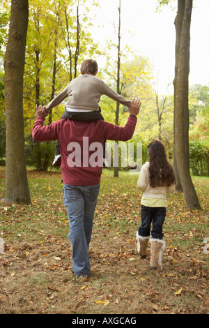 Father and Children Walking in Autumn