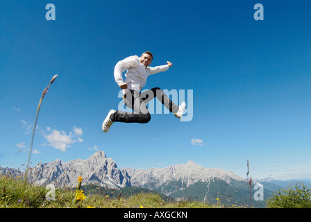 Man Jumping by Mountain Range