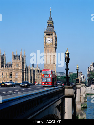 Red double decker bus crossing Westminster Bridge in front of Big Ben and the Houses of Parliament, London, England, UK, GB Stock Photo