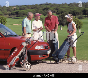 retired age couples on golf course by their hired car Stock Photo