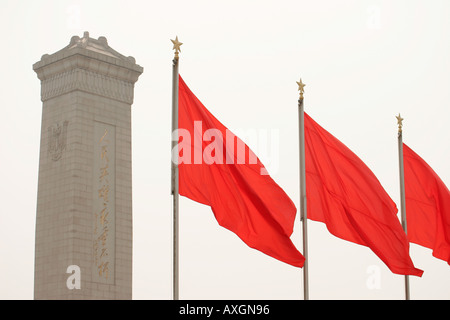 The monument to the people's heroes and red flags in Tiananmen Square in Beijing China Stock Photo