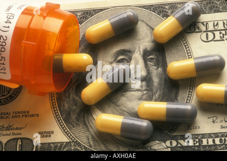 medical capsules displayed on a 100 dollar bill USA concept Stock Photo