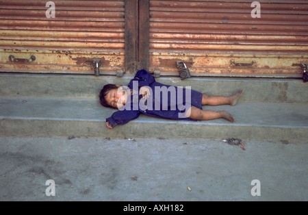 Homeless Child sleeping in the streets of Kathmandhu Nepal Stock Photo