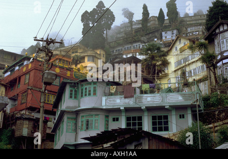 Old houses of the centre of the town are hidden partially in the mist in Darjeeling India Stock Photo