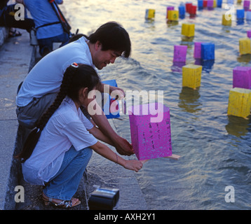 Floating lanterns on August 6th, Hiroshima, Japan. Placed in the river beside the A-Bomb Dome ( a UNESCO World Heritage Site. ) Stock Photo