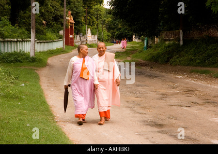 Stock photograph of two older nuns enjoying a chat at Sagaing Hill near Mandalay in Myanmar 2006 Stock Photo