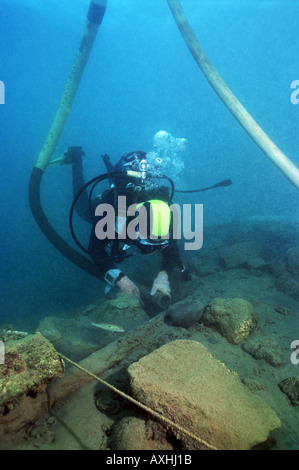 scubadiver carrying out excavations in an underwater archeological site Stock Photo