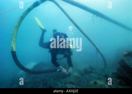 scubadiver carrying out excavations in an underwater archeological site Stock Photo