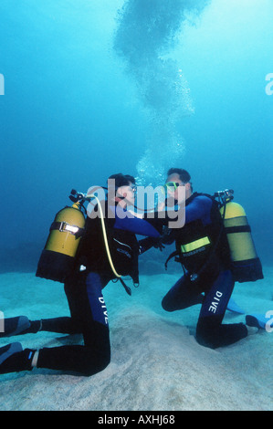 two scubadiver doing excercise on the seabed Stock Photo