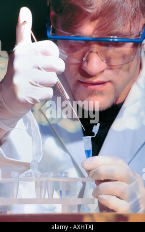 genetic engineering researcher extracting DNA from sample Stock Photo