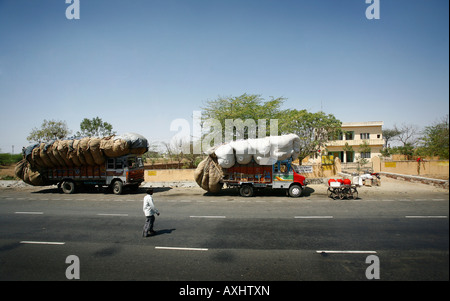 Overloaded Tata lorrys on the road side between Agra and Jaipur India. Picture by James Boardman Stock Photo