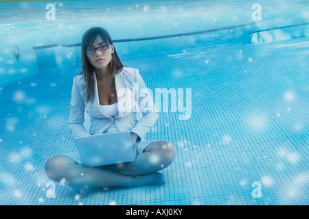South American businesswoman in swimming pool Stock Photo