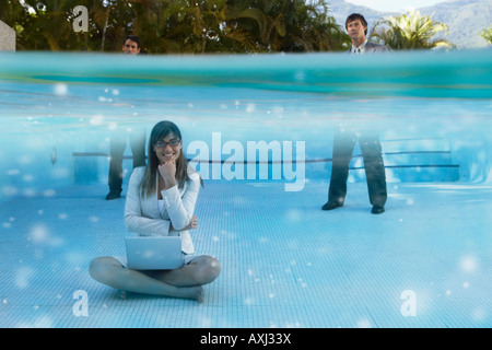 South American businesspeople in swimming pool Stock Photo