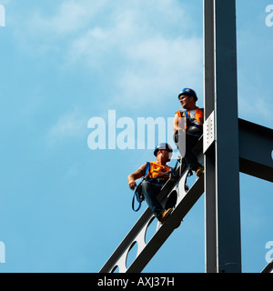 steeplejacks on girder during construction work Stock Photo