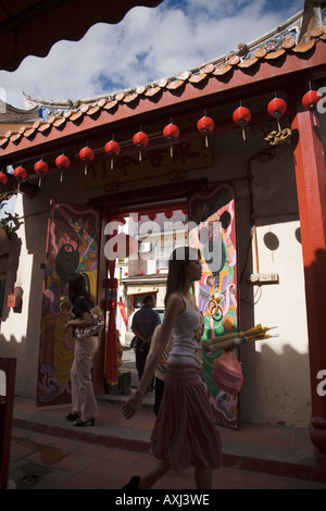 Entrance to Cheng Hoon Teng Temple, Melaka, Malaysia, as seen from the inside of the temple. And worshipers in temple Stock Photo