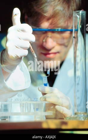 reseracher molecular biology handling a sample with DNA in laboratory Stock Photo