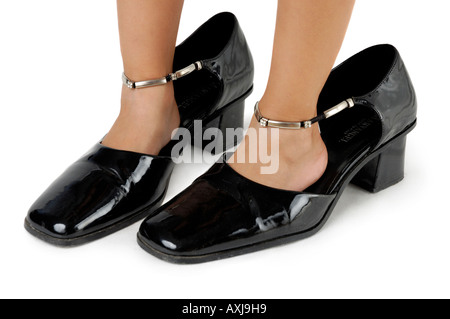 Little girl in big mother shoes Stock Photo