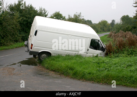 A white van crashed into a ditch. Stock Photo